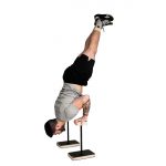 man performing a press to handstand on wooden forte fitness canes