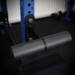 nordic curl attachment mounted on a blue rack