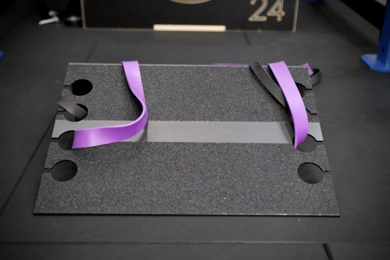 slant platform set up in a gym with purple resistance band