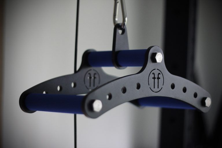A close-up picture of the Forte Fitness cable row attachment. It shows 2 black curved bars joined together with 3 blue gripped handles.