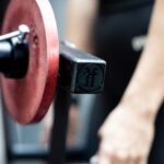 close up of a woman doing a lat raise with a lateral raise rack attachment