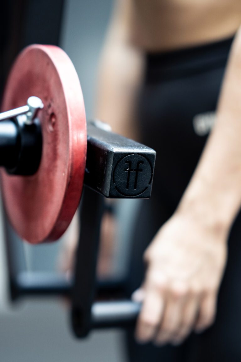 close up of a woman doing a lat raise with a lateral raise rack attachment