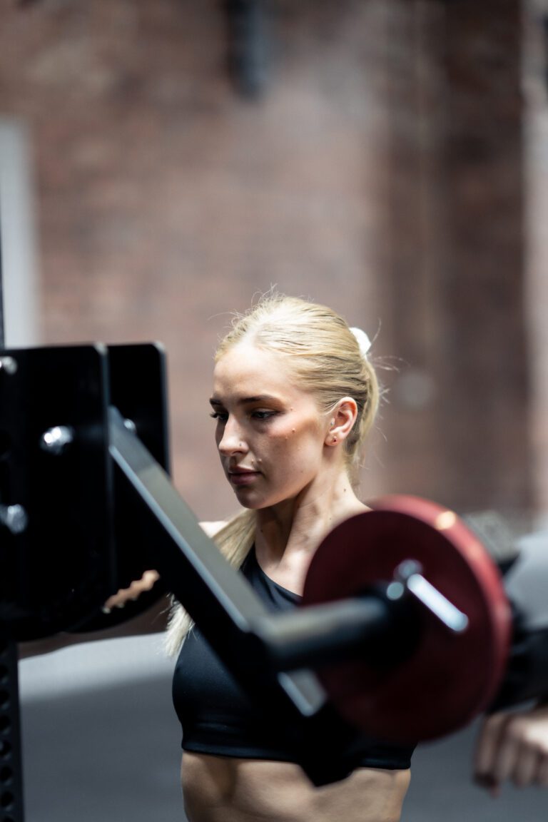 close up of a woman doing a lat raise with a lateral raise rack attachment