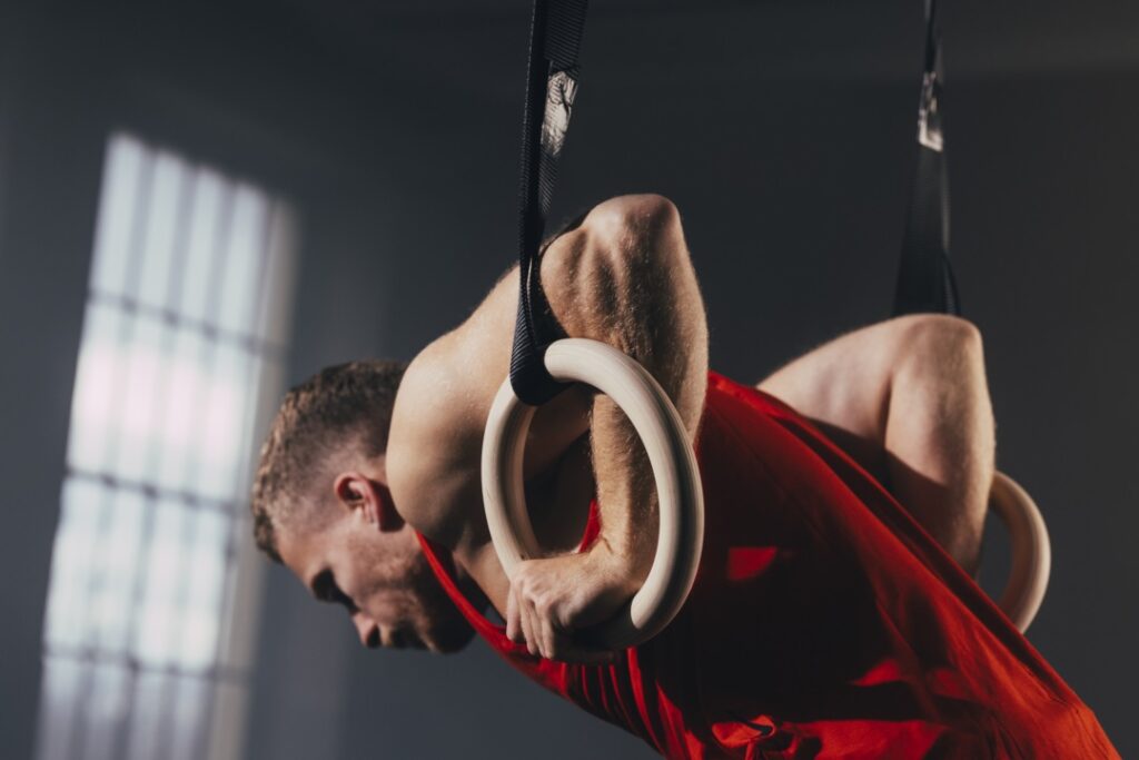 a serious sportsman exercising on gymnastic rings