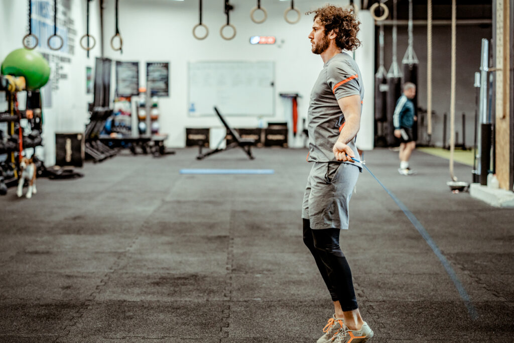 man in a crossfit gym practising double unders