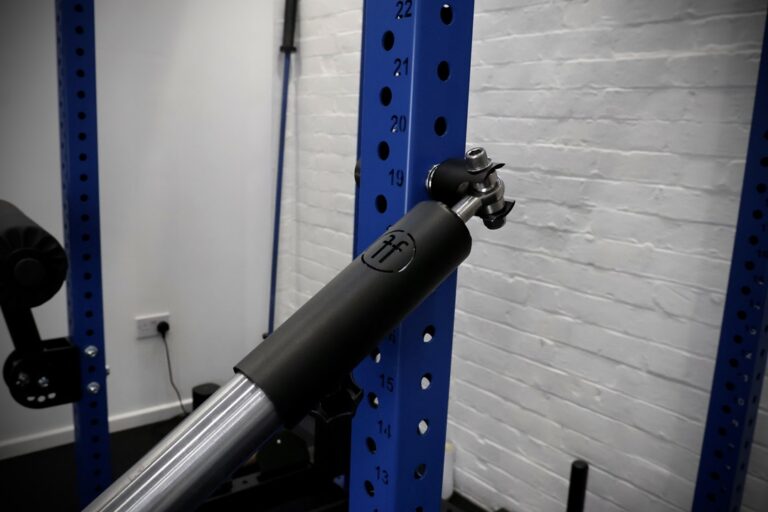 landmine attachment setup on a blue rack with barbell