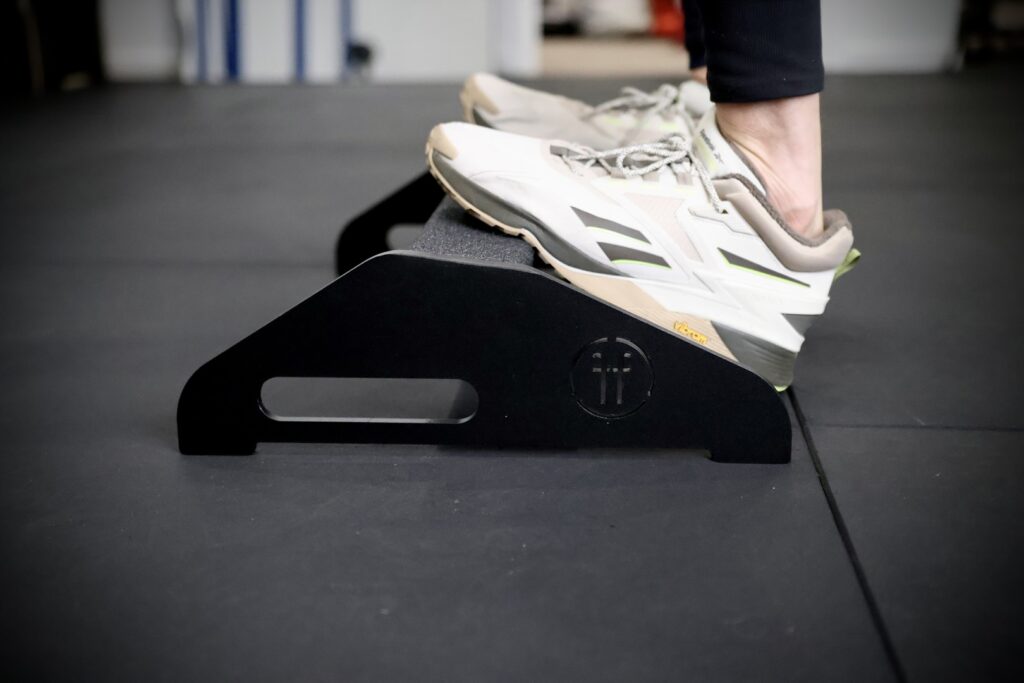 close up of a man doing calf raise on a calf raise platform