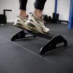 close up of a man doing calf raise on a calf raise platform