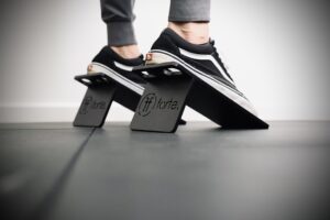 close up of man's feet standing on some slant blocks ready to squat