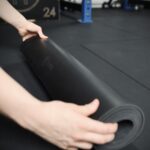 girl unrolling the forte fitness yoga mat