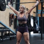 woman performing a snatch weightlifting movement wearing a hybrid lifting belt